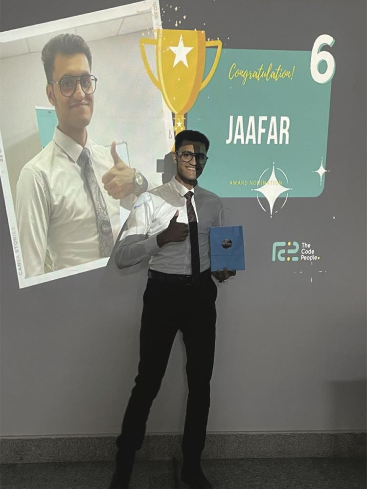 Standing in front of a projected slide showing an award nomination